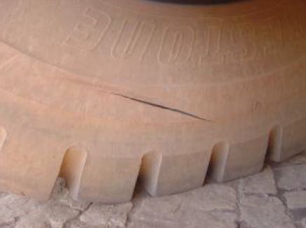 During mining operations, stone impact caused damage to a truck tire, resulting in a cut that extended down to the metal mesh