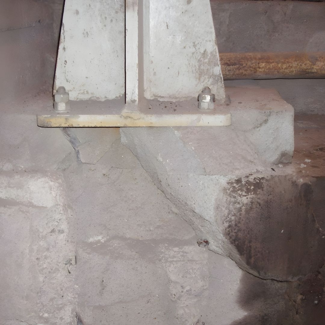 Damaged concrete foundation prior to application of epoxy concrete repair system 