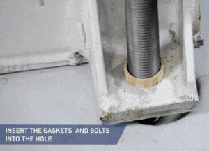 Insert the prepared anchor bolts into the holes