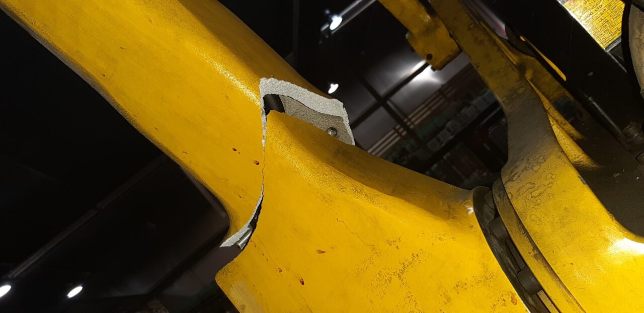 Shear failure if robotic arm in a food and beverage manufacturing facility